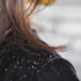 Woman hair with dandruff falling on shoulders