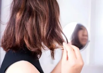 closeup woman have problem with heat damage or dry hair, split ends and hair texture thinning