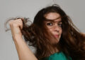 A young woman with rumpled hair