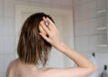 Woman makes a head self massage for hair growth