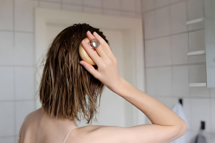 Woman makes a head self massage for hair growth