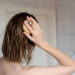 Woman makes a head self massage for hair growth