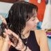 Young Woman Taking Care of her Hair at Home