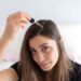 Applying Hair Serum To Her Hair