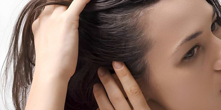 Young worried woman checking her hair and scalp