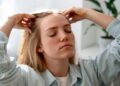 woman giving herself scalp massage