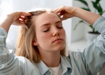 woman giving herself scalp massage