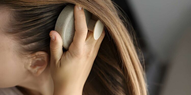 woman massaging her scalp
