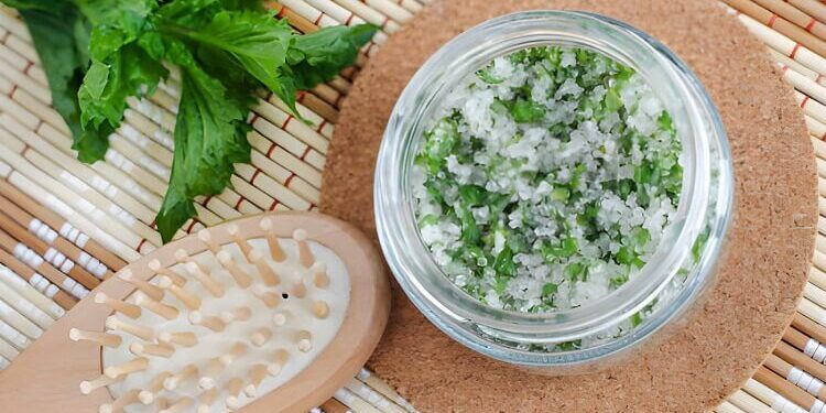 Homemade mint exfoliating scrub (scalp peeling, bath salt) with sugar, chopped mint leaves, olive oil and essential mint oil. Natural skin and hair care